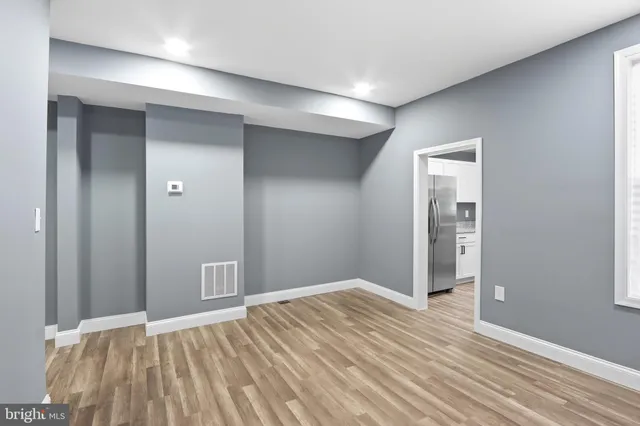 an empty room with closet and wooden floor