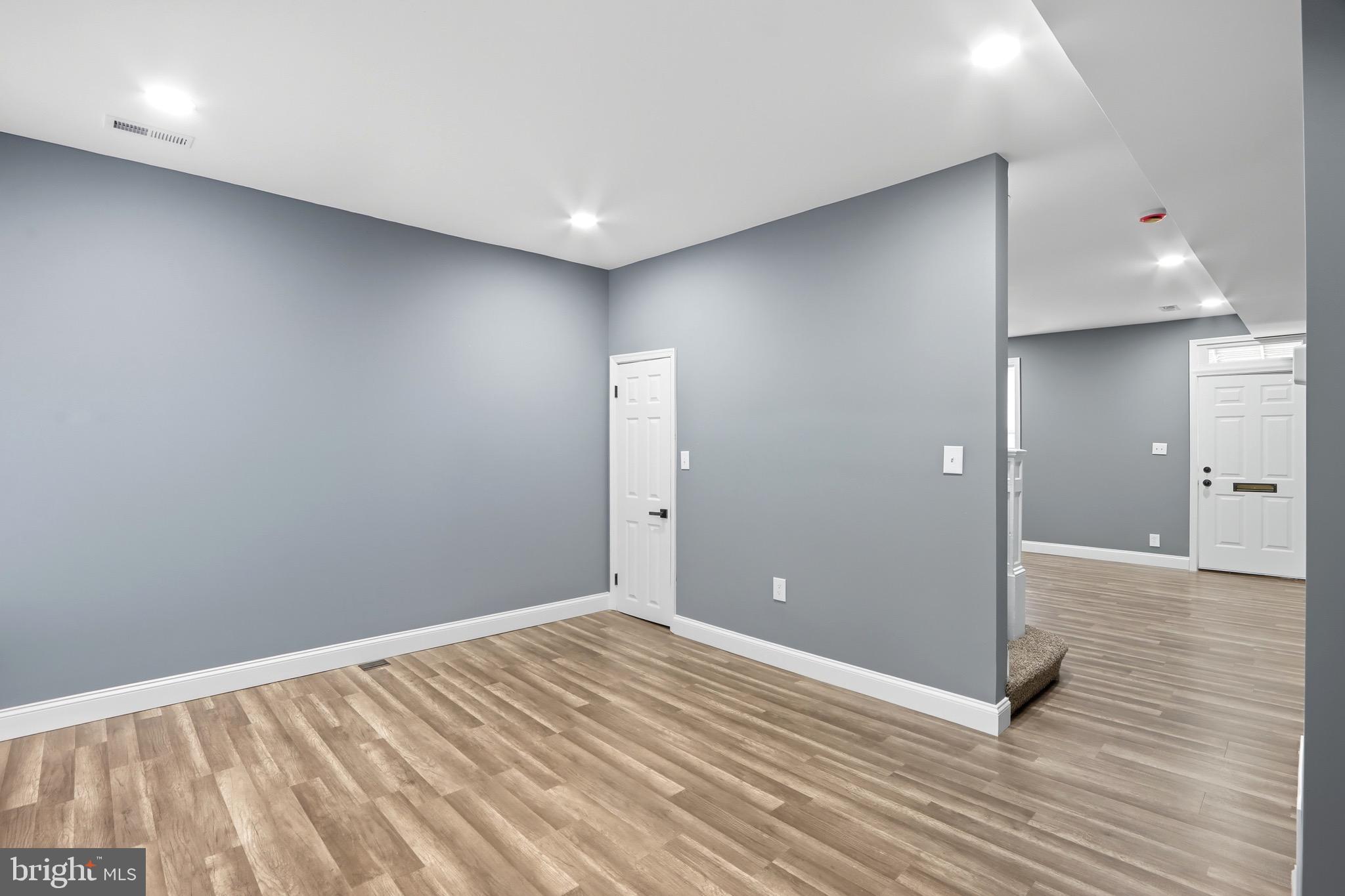 1309 East Patapsco Avenue Baltimore, MD 21225 - Photo 10 of 34 wooden floor in an empty room with a window