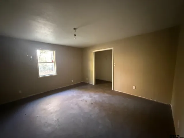 an empty room with windows and closet
