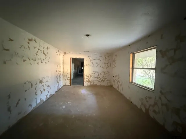 a view of an empty room and window