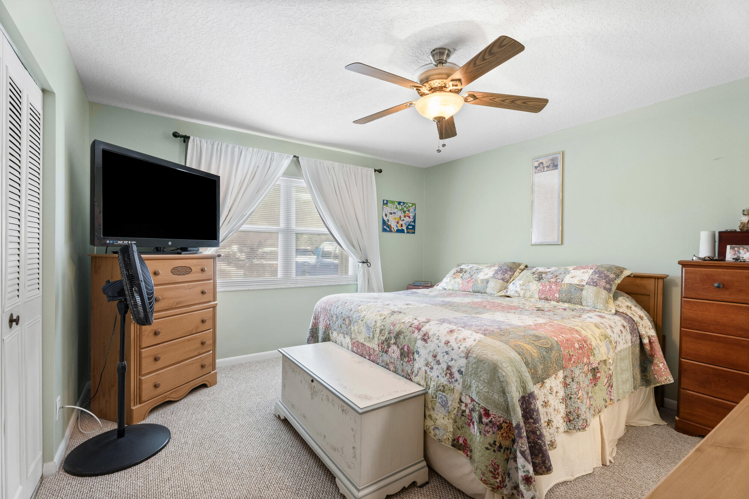 1341 Southeast Seashell Lane Stuart, FL 34996 - Photo 11 of 24 a bedroom with a bed and a flat screen tv