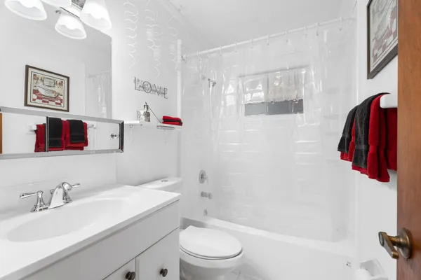 a bathroom with a sink a toilet and a shower