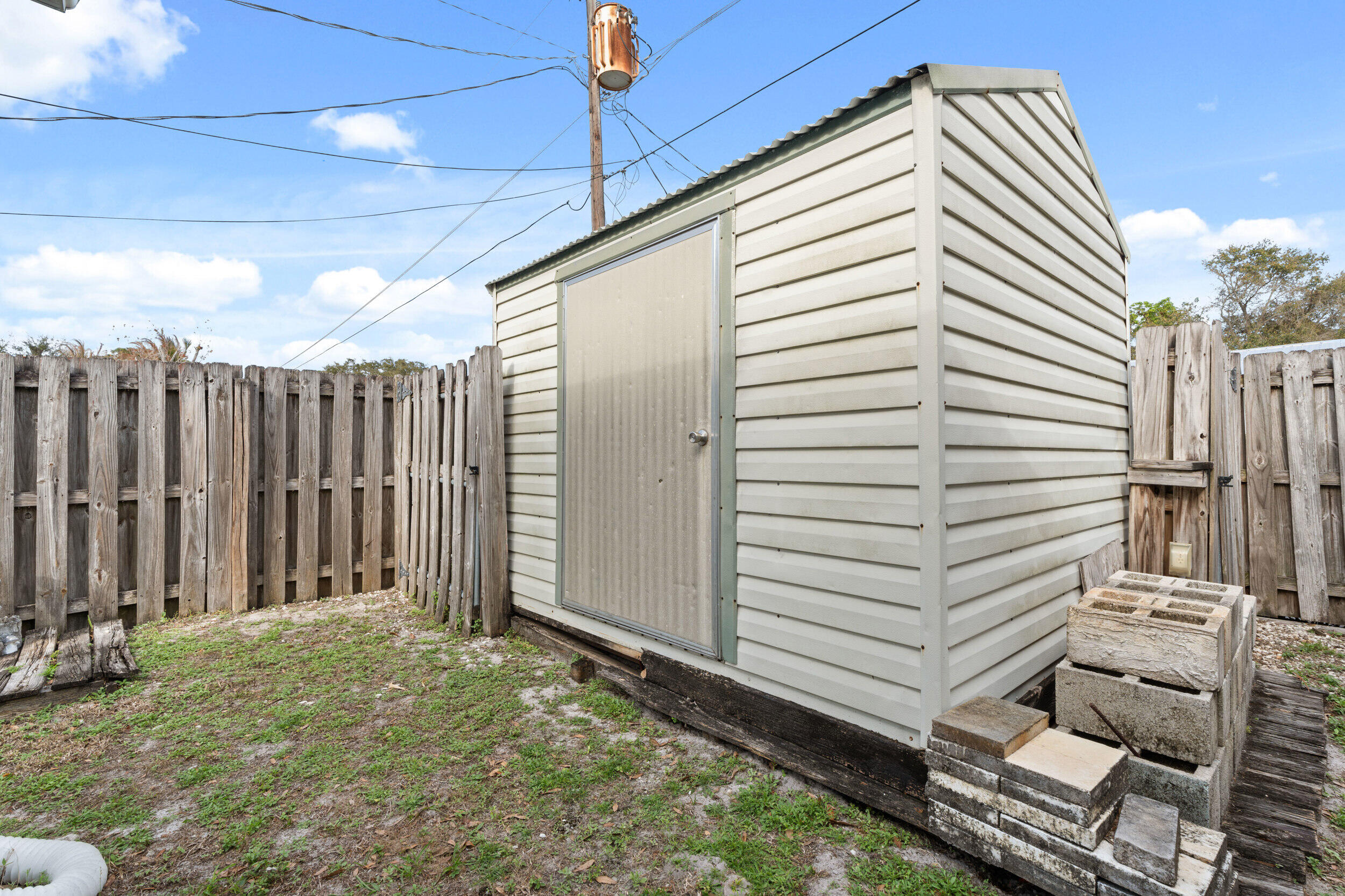 1341 Southeast Seashell Lane Stuart, FL 34996 - Photo 22 of 24 a view of a backyard with wooden fence