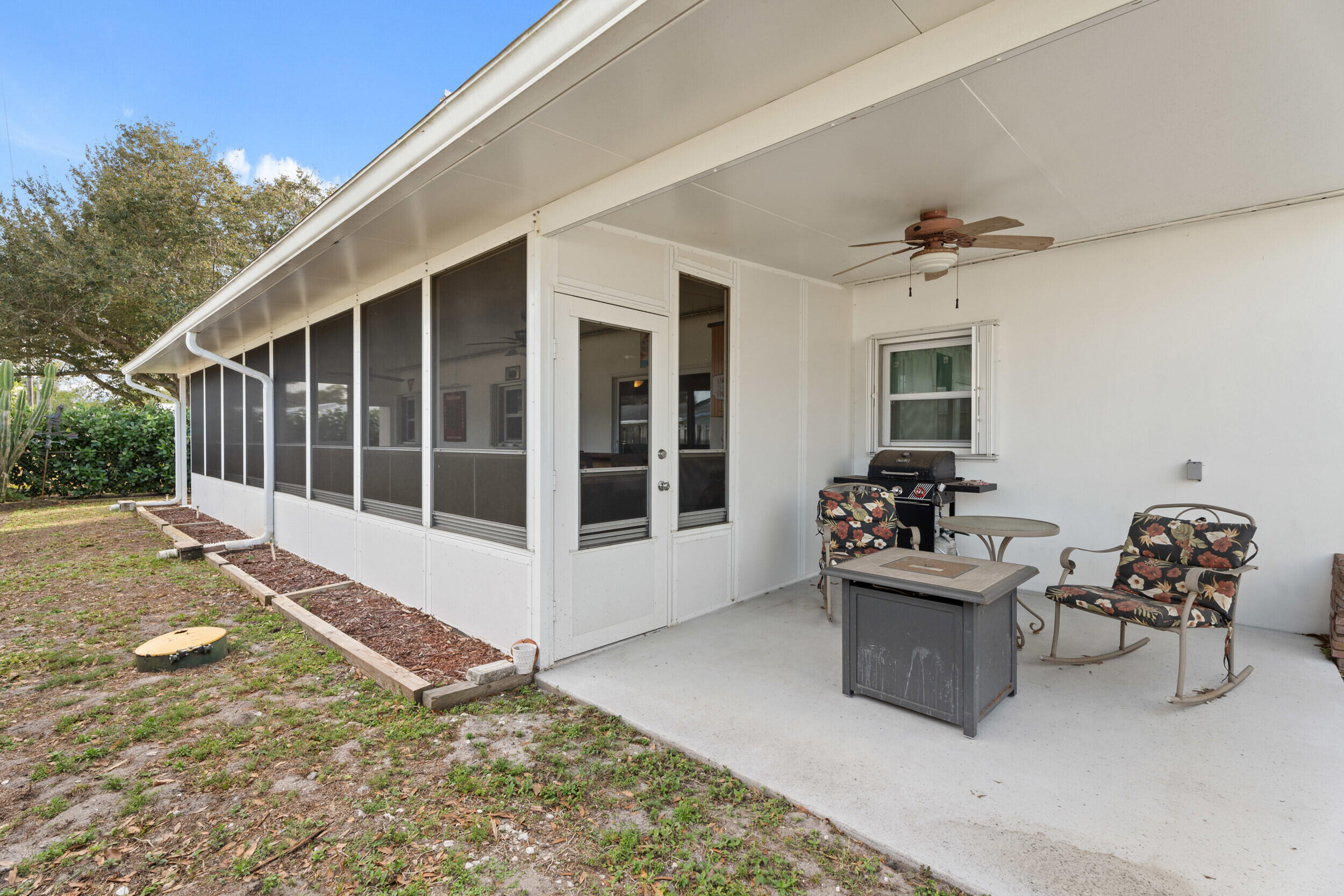 1341 Southeast Seashell Lane Stuart, FL 34996 - Photo 23 of 24 a view of a house with backyard sitting area and garden