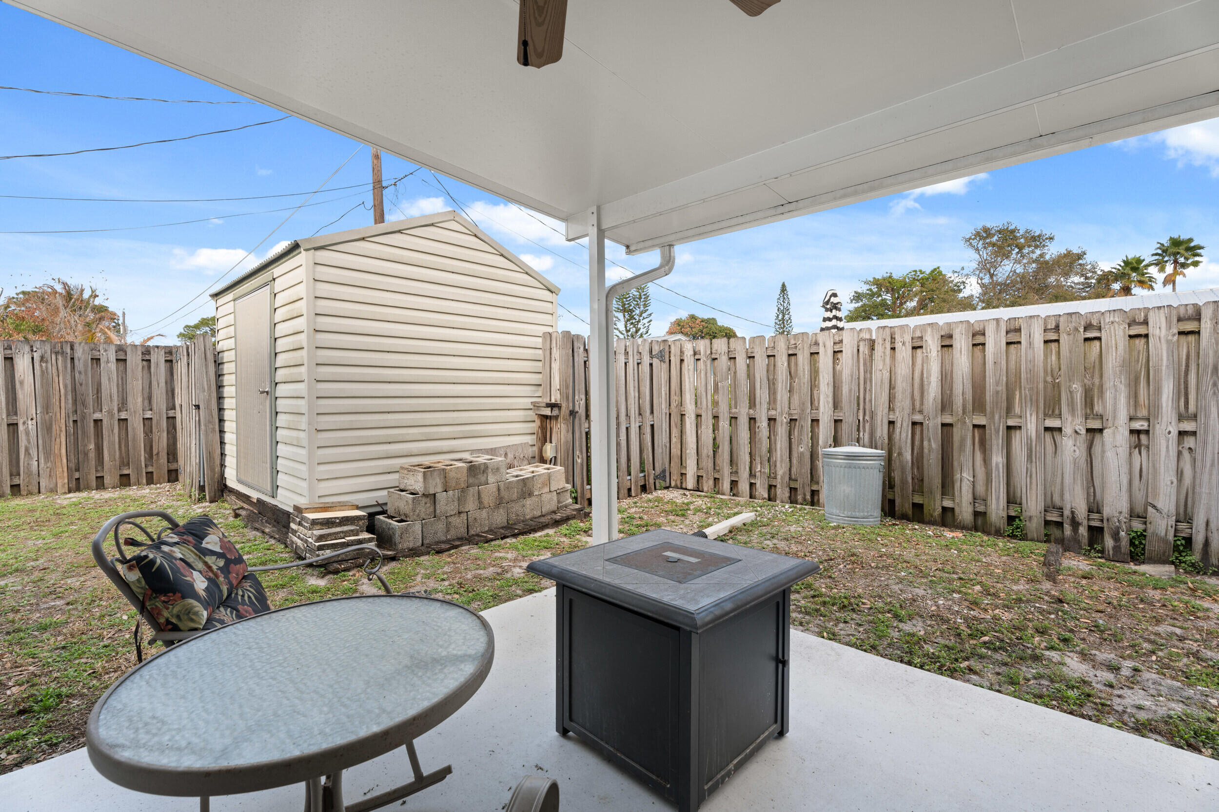 1341 Southeast Seashell Lane Stuart, FL 34996 - Photo 24 of 24 a backyard of a house with table and chairs