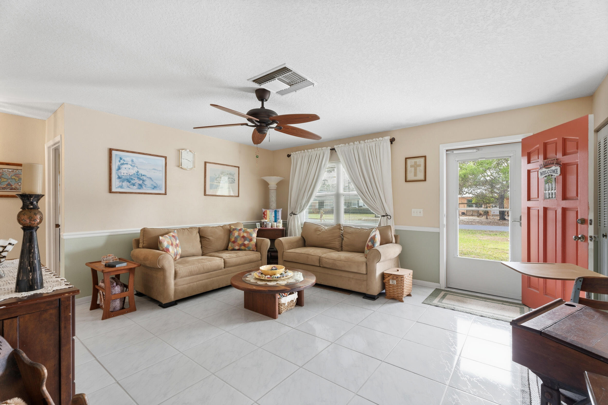 1341 Southeast Seashell Lane Stuart, FL 34996 - Photo 3 of 24 a living room with furniture and a large window