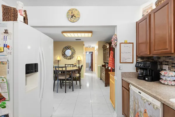 a view of a kitchen with dining area and stainless steel appliances