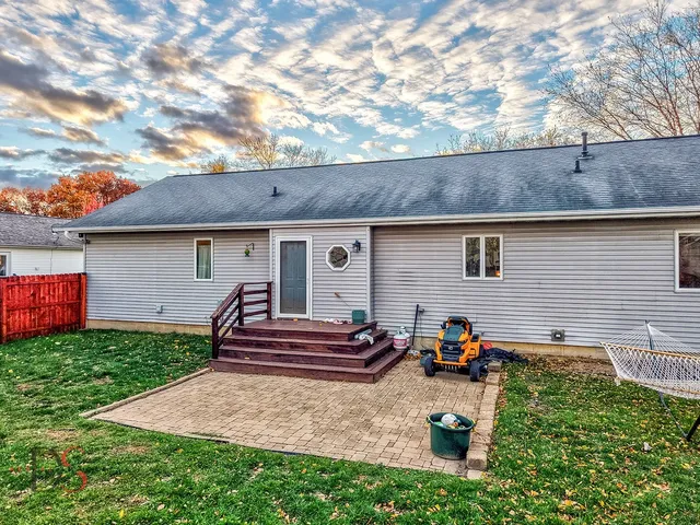 an aerial view of a house with a yard and a fountain