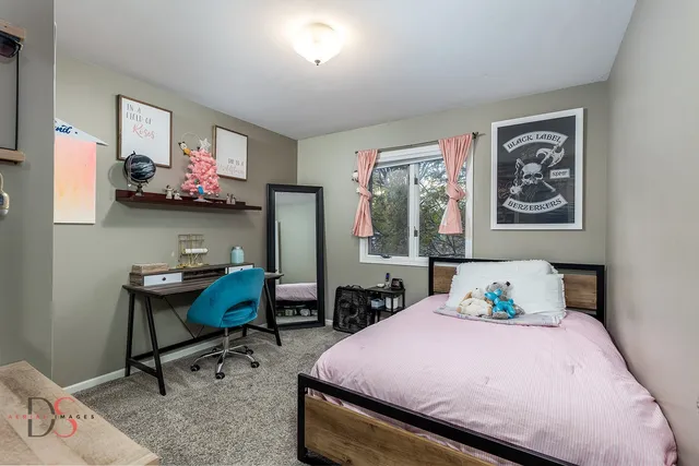 a bedroom with a bed a desk and chair