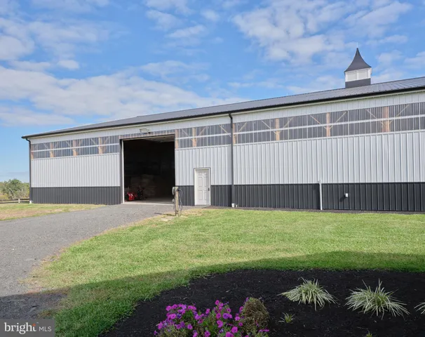 an aerial view of a house with outdoor space swimming pool and mountains