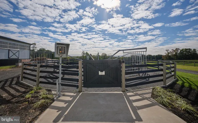 an aerial view of a house with swimming pool and a yard