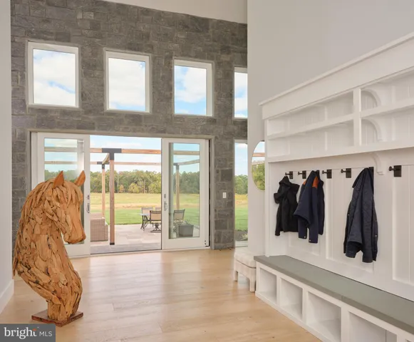 an aerial view of a house with a garden and lake view