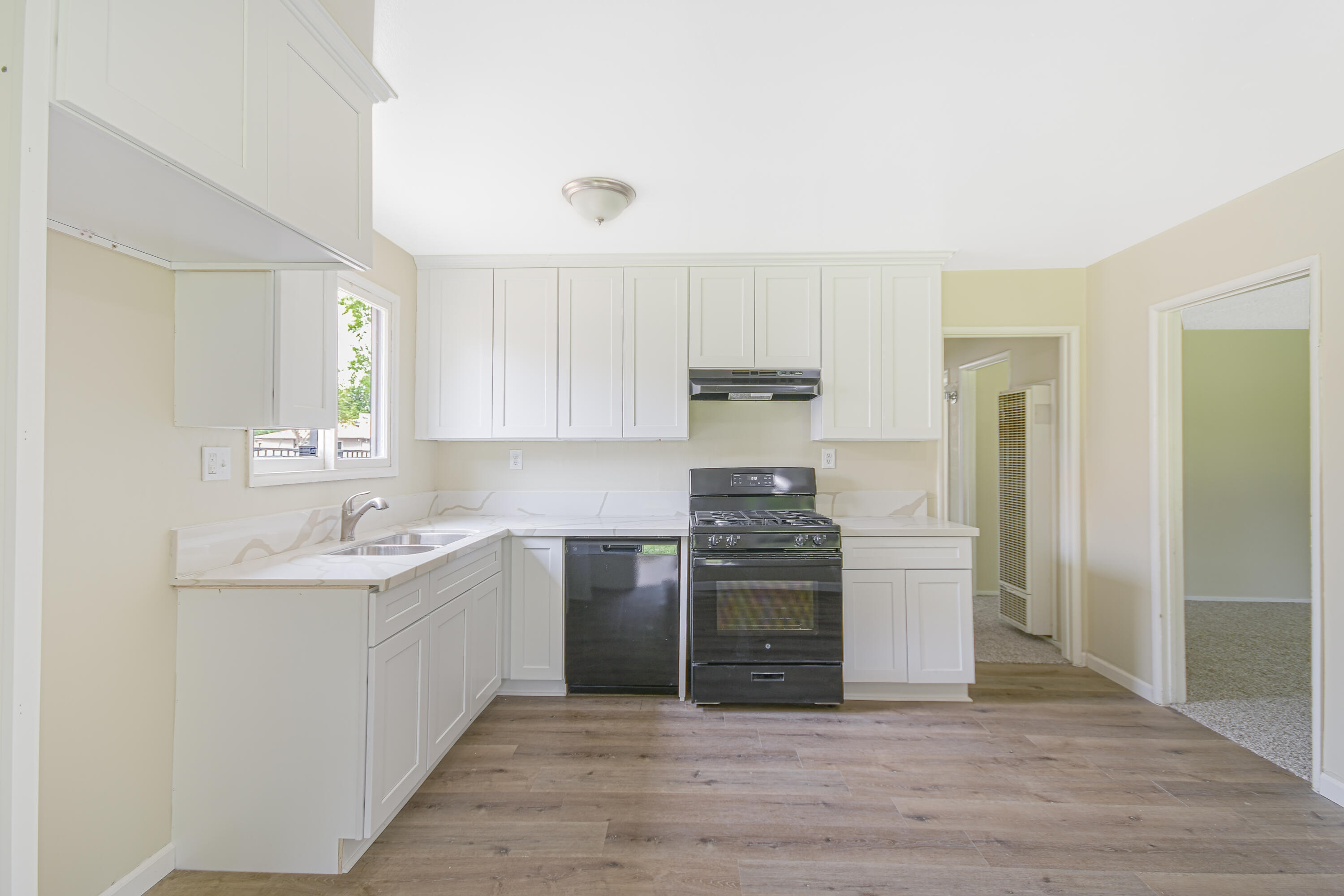 44325 3rd Street East Lancaster, CA 93535 - Photo 4 of 15 a kitchen with stainless steel appliances granite countertop a sink and refrigerator