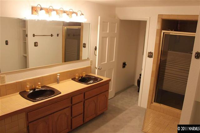 4215 Lakeside Drive Reno, NV 89509 - Photo 12 of 13 a bathroom with a sink double vanity and a mirror