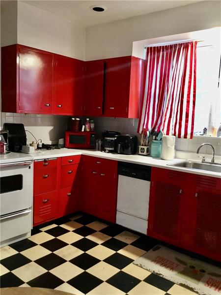 303 South Second Street Apollo, PA 15613 - Photo 12 of 25 a kitchen with a sink a stove cabinets and a chair