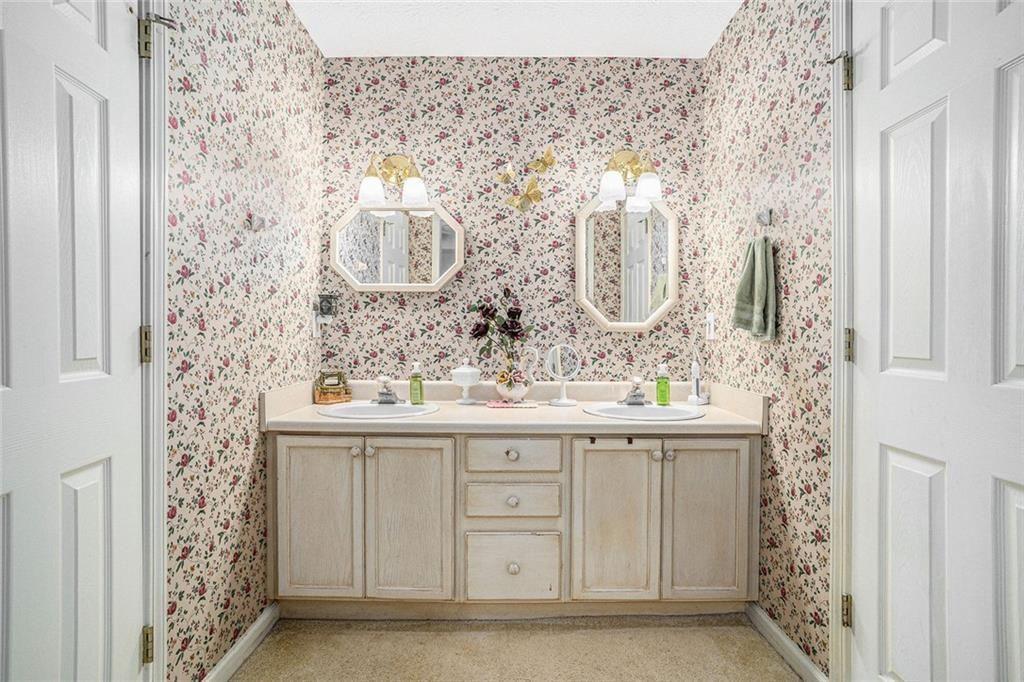 45 Saratoga Way Covington, GA 30016 - Photo 18 of 29 a bathroom with a sink and a mirror