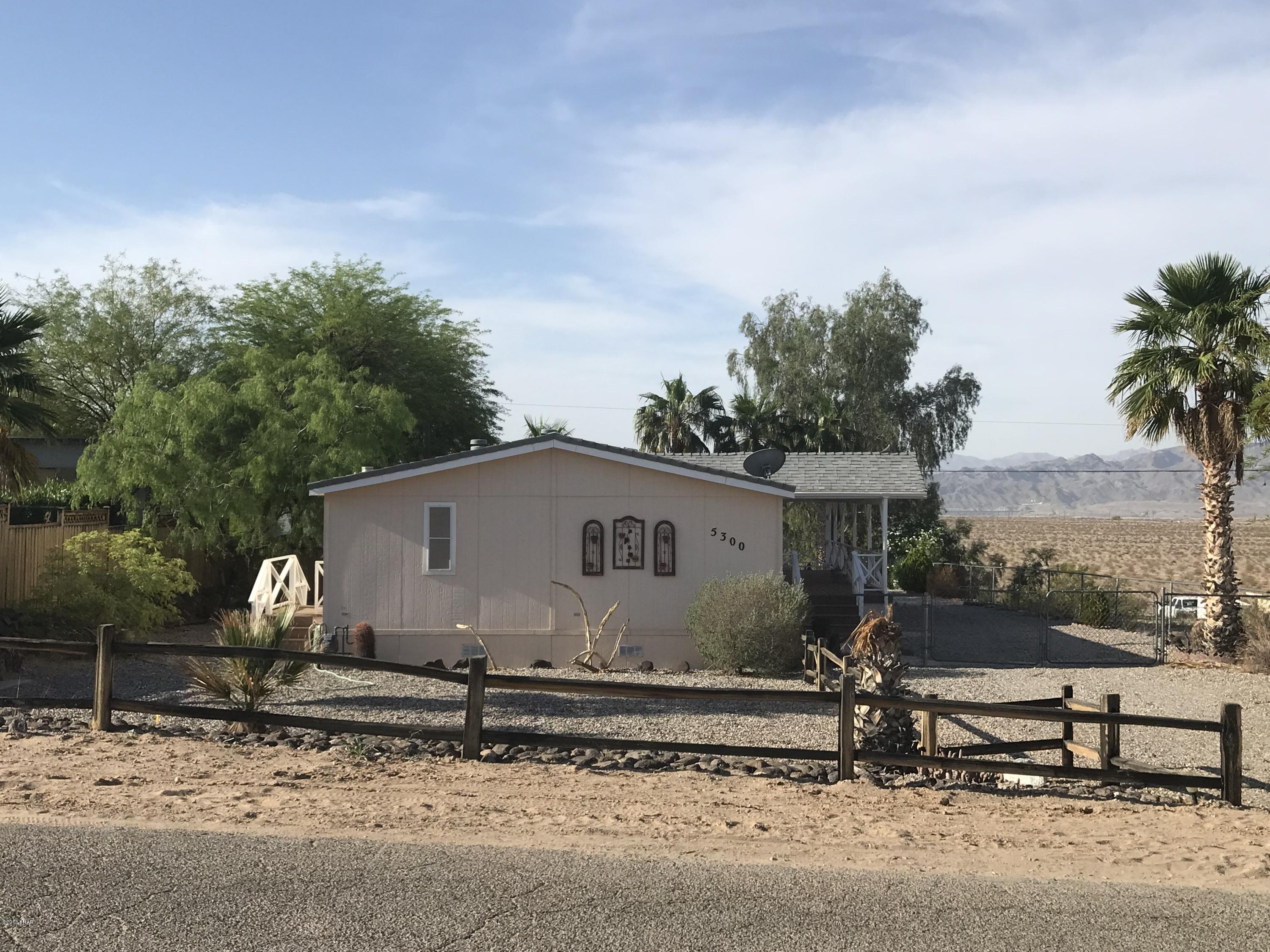 5300 Pinal Place Topock, AZ 86436 - Photo 1 of 1 a white house with tree in front of it