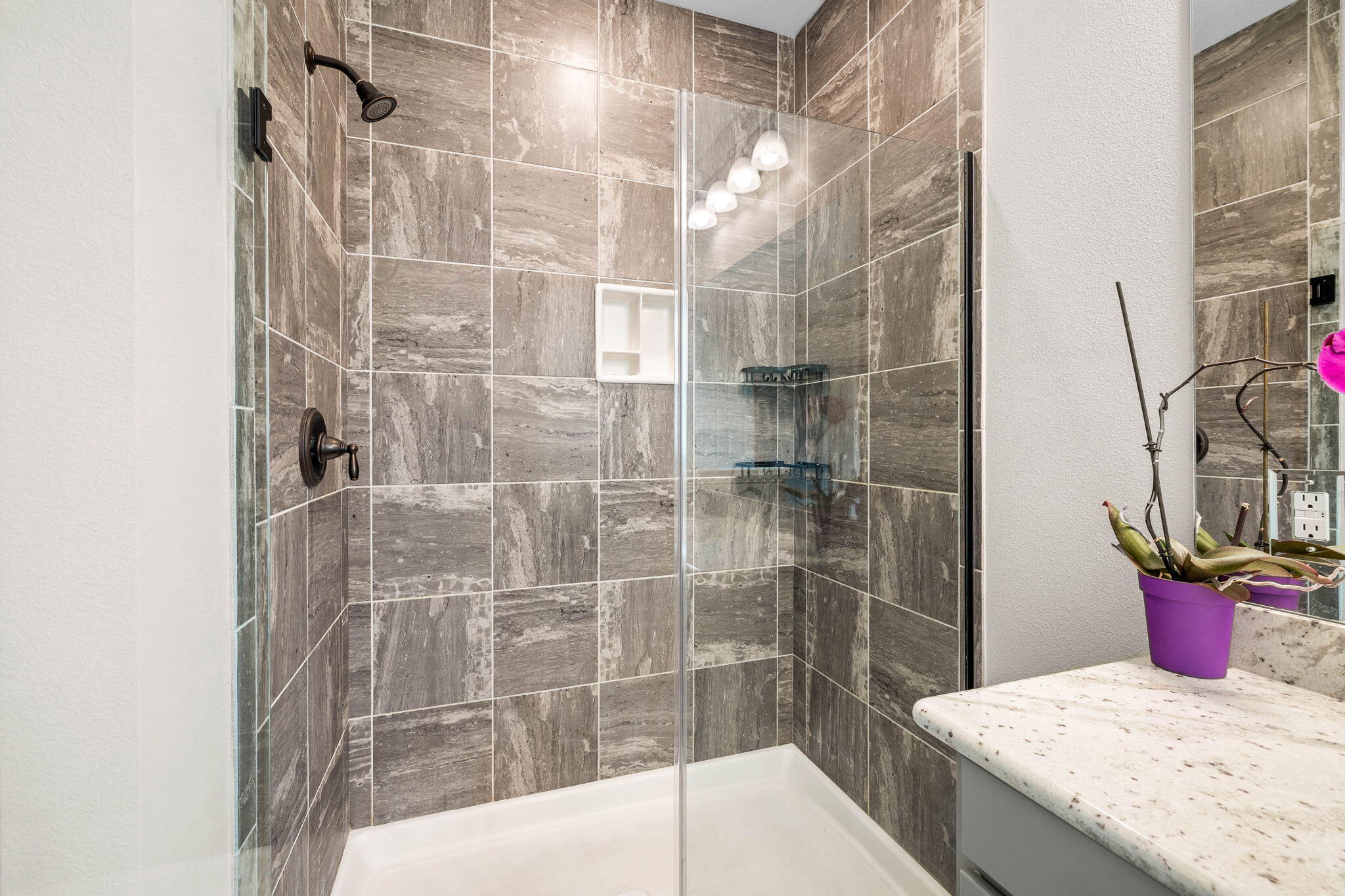 1297 Brushed Dune Circle Freeport, FL 32439 - Photo 33 of 73 a bathroom with a granite countertop sink a toilet and shower