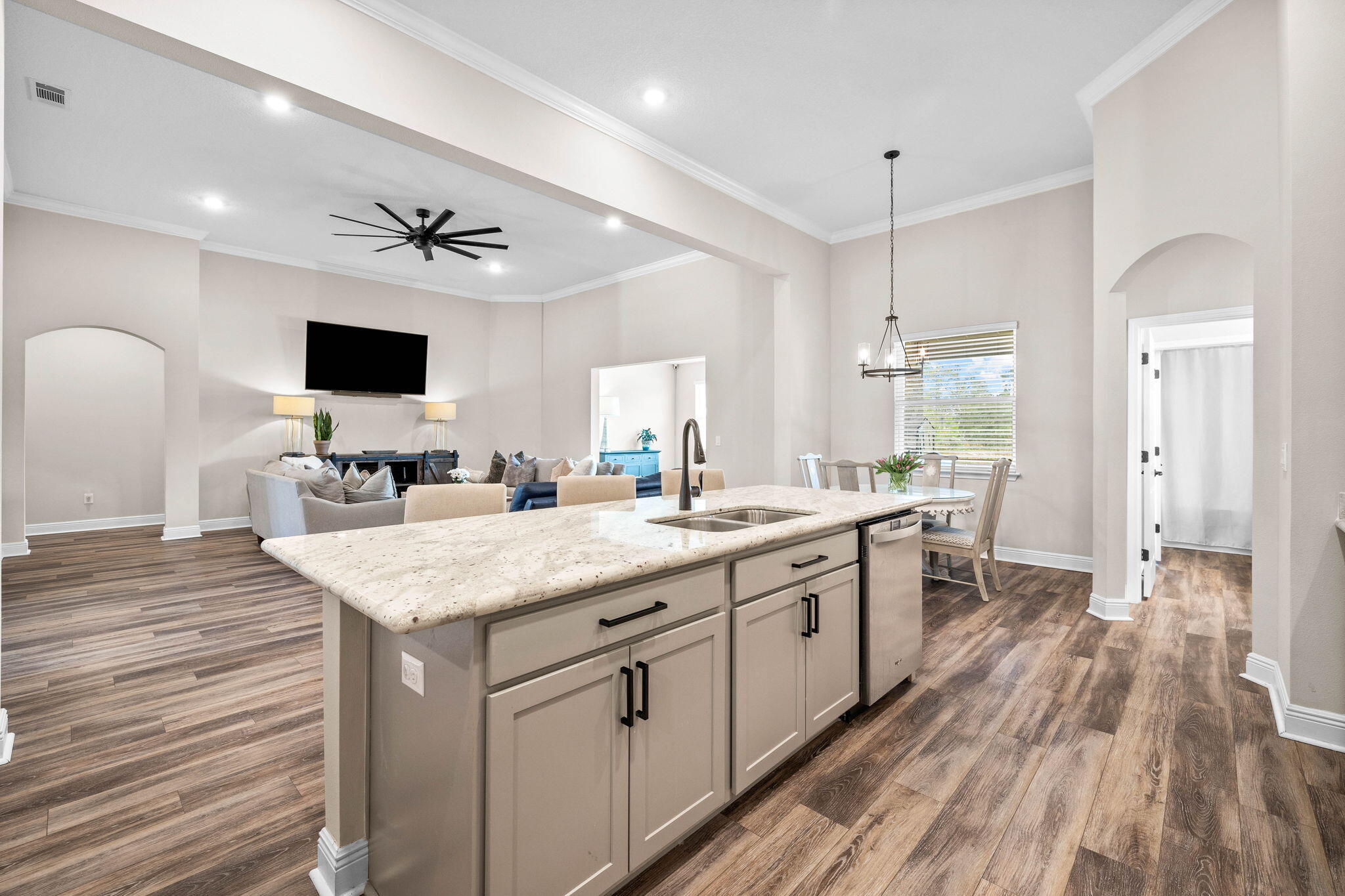 1297 Brushed Dune Circle Freeport, FL 32439 - Photo 37 of 73 a large kitchen with a center island wooden floor and stainless steel appliances