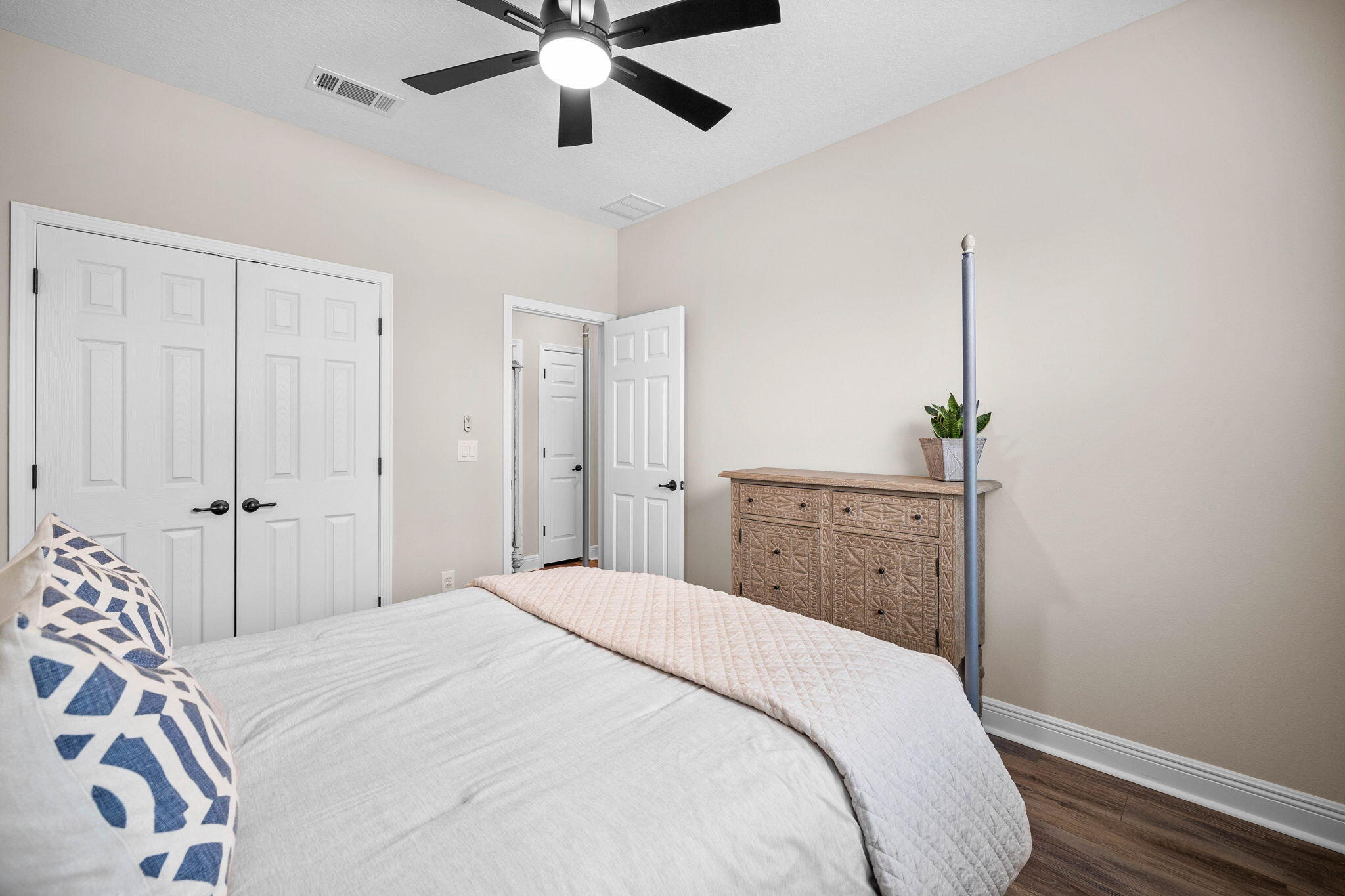 1297 Brushed Dune Circle Freeport, FL 32439 - Photo 41 of 73 a spacious bedroom with a bed and a chandelier