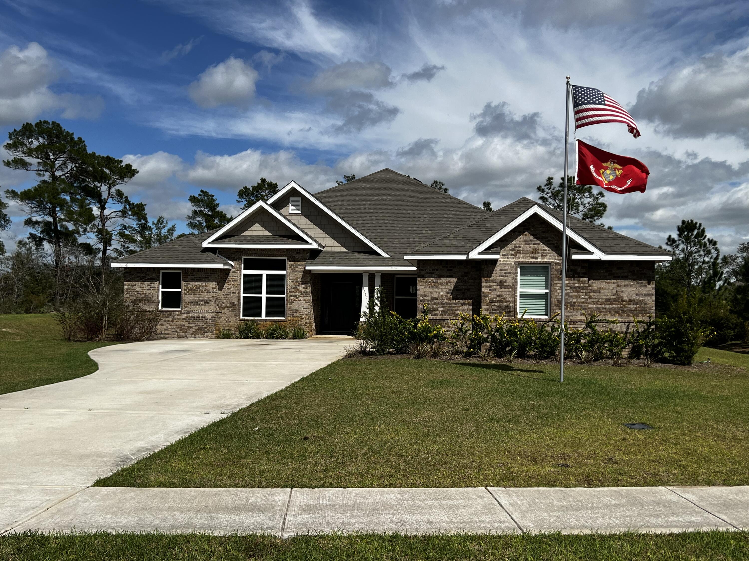 1297 Brushed Dune Circle Freeport, FL 32439 - Photo 60 of 73 a front view of a house with a yard