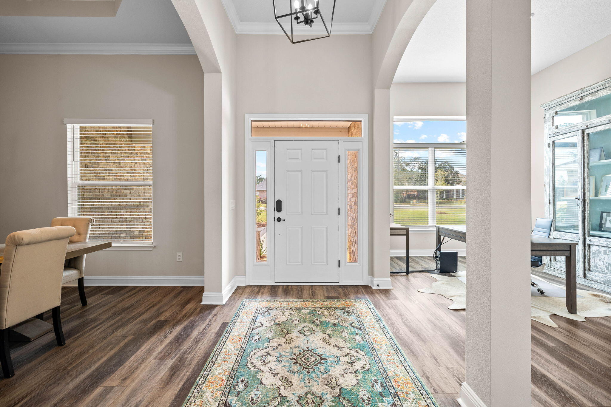 1297 Brushed Dune Circle Freeport, FL 32439 - Photo 10 of 73 a view of a hallway to a livingroom with wooden floor and a window