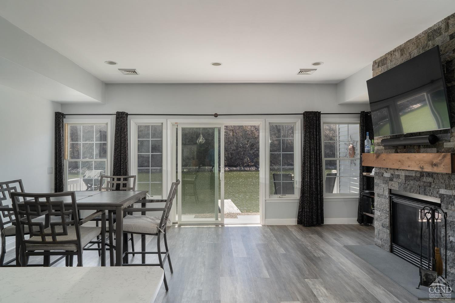 19 Marina Drive Catskill, NY 12414 - Photo 2 of 10 a dining room with furniture large windows and a fireplace