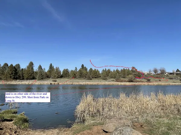 a view of a lake with houses in the background