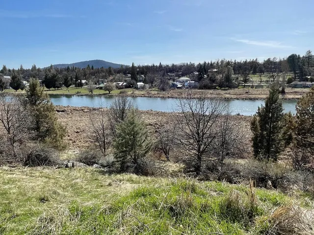 a view of a lake with houses in the back