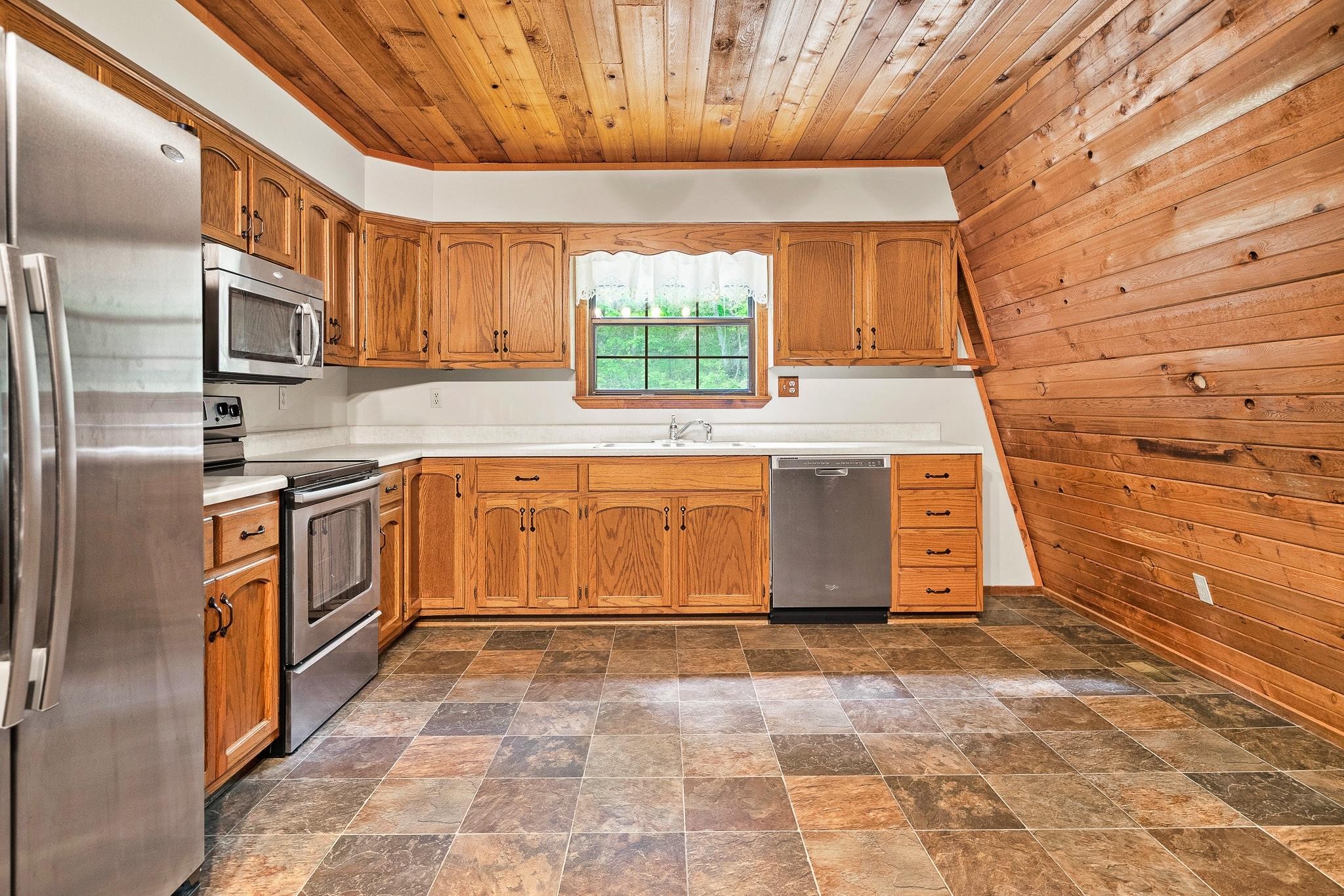 916 Gamble Drive Heiskell, TN 37754 - Photo 11 of 29 a kitchen with stainless steel appliances granite countertop a stove a sink and a refrigerator