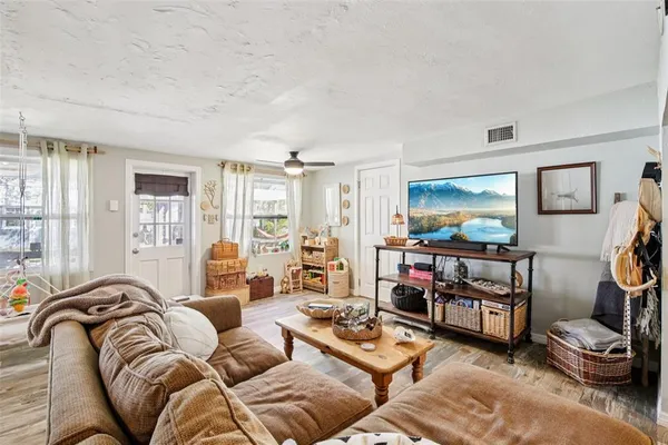a living room with furniture and wooden floor