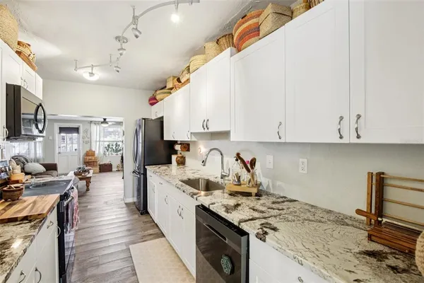 a kitchen with stainless steel appliances a stove sink microwave and cabinets