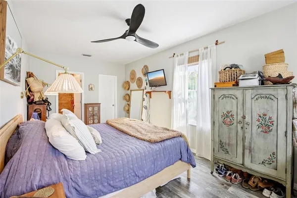 a bedroom with a bed and a tv on table