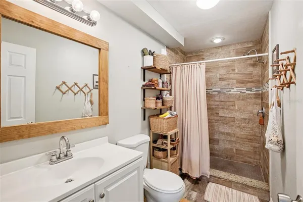 a bathroom with a sink mirror and toilet