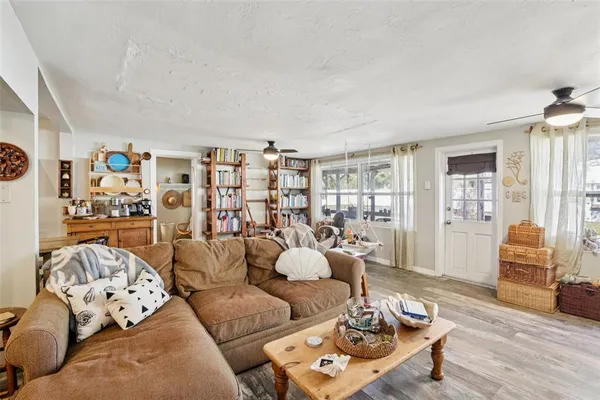 a living room with furniture and wooden floor