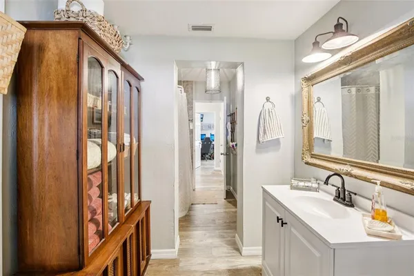 a bathroom with a sink a mirror and a shower