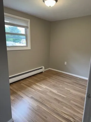 a view of a room with wooden floor and windows