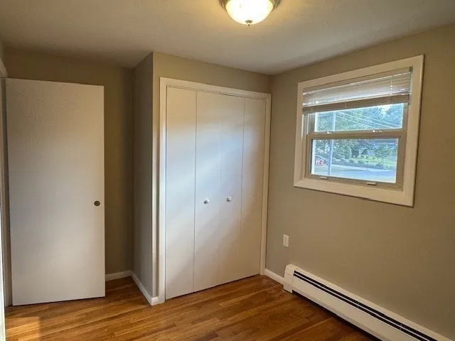 a view of room with wooden floor and window
