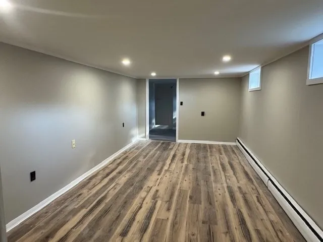 a view of room with wooden floor