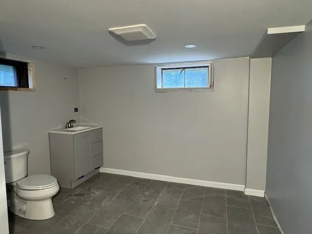 a white toilet sitting next to a bathroom sink