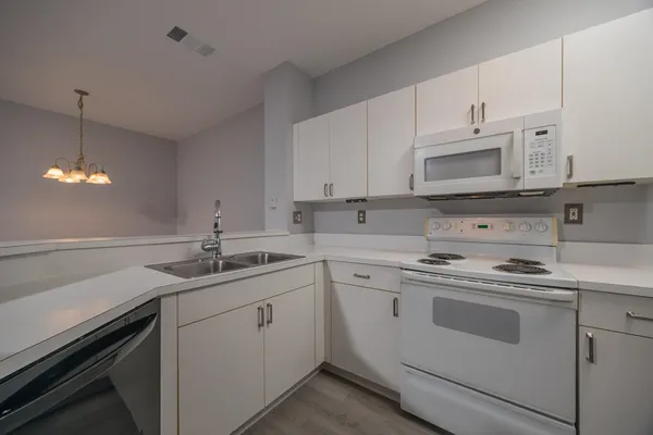a kitchen with cabinets stainless steel appliances and a sink