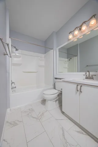 a view of a green field with lots of bushes