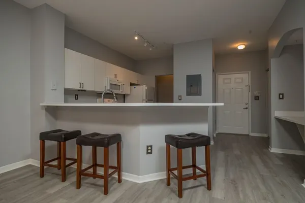 a kitchen with kitchen island a sink stainless steel appliances and cabinets
