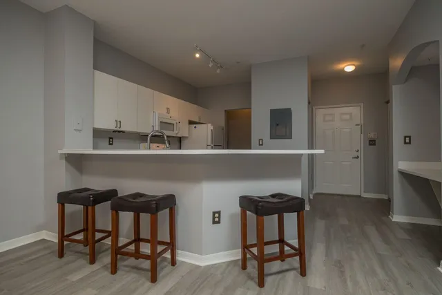 a kitchen with kitchen island a sink stainless steel appliances and cabinets