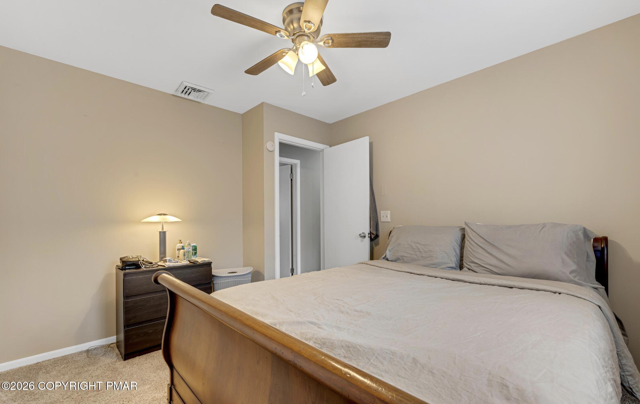 3337 Ross Road Tobyhanna, PA 18466 - Photo 3 of 10 a bedroom with a bed and a ceiling fan