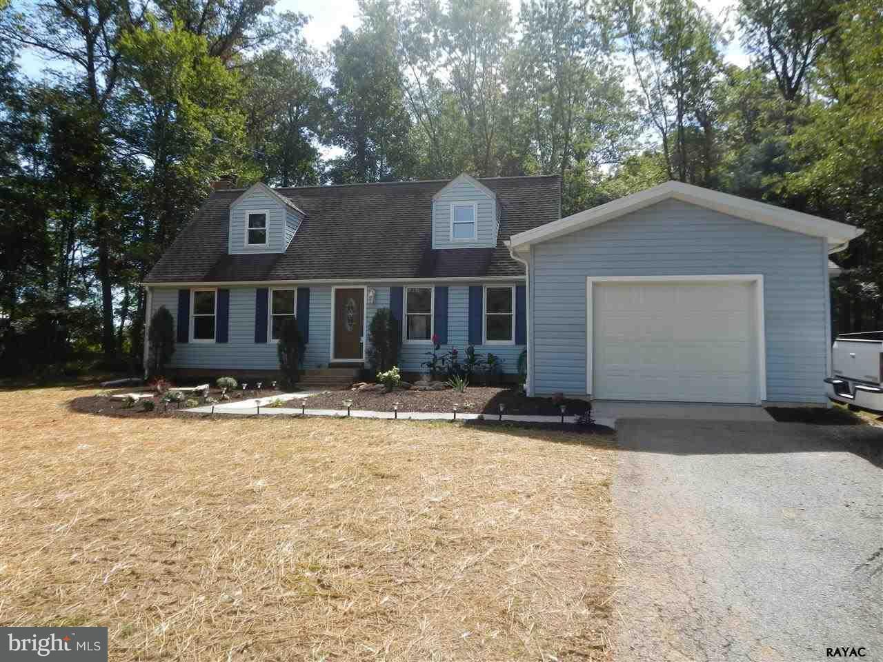 7952 Hickory Road Stewartstown, PA 17363 - Photo 1 of 14 a front view of a house with a yard and garage