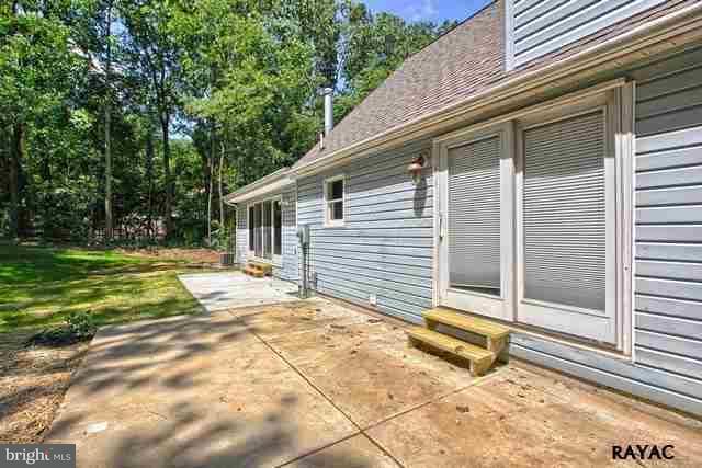 7952 Hickory Road Stewartstown, PA 17363 - Photo 12 of 14 a view of a house with backyard and a large tree