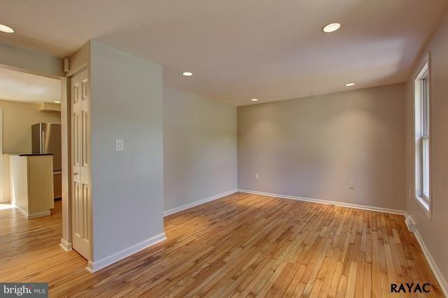 7952 Hickory Road Stewartstown, PA 17363 - Photo 2 of 14 wooden floor in an empty room with a window