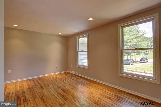 7952 Hickory Road Stewartstown, PA 17363 - Photo 3 of 14 a view of empty room with wooden floor and fan