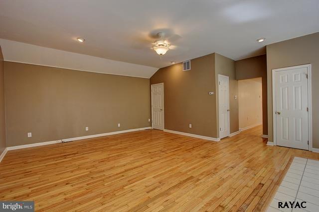 7952 Hickory Road Stewartstown, PA 17363 - Photo 6 of 14 a view of an empty room with wooden floor and a bathroom